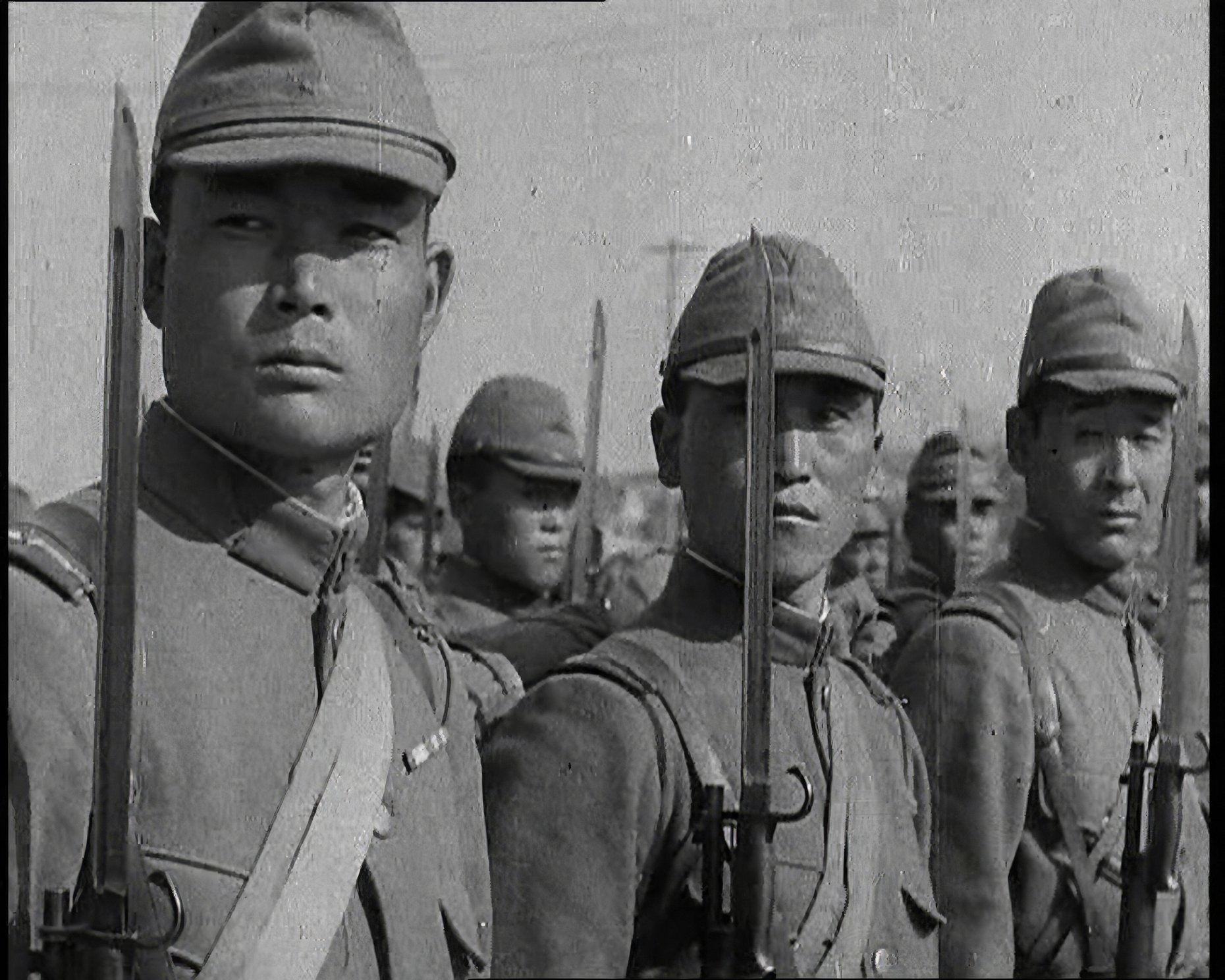 Close up of Male Japanese Soldiers Standing to Attention and Holding Their Bayonets Looking to the Right, 1938.